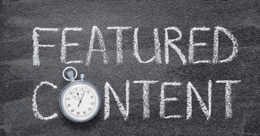 The words Featured Content written on a chalkboard with a stopwatch beside them