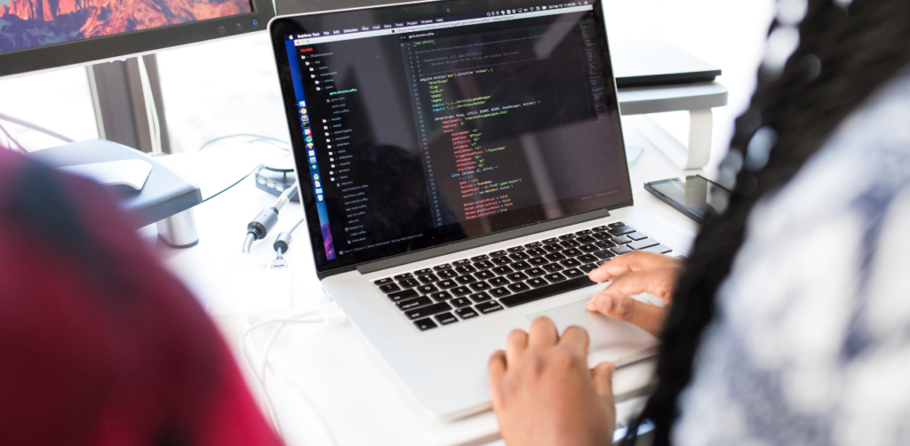 Programmer coding on a laptop, symbolizing website development and technical SEO improvements