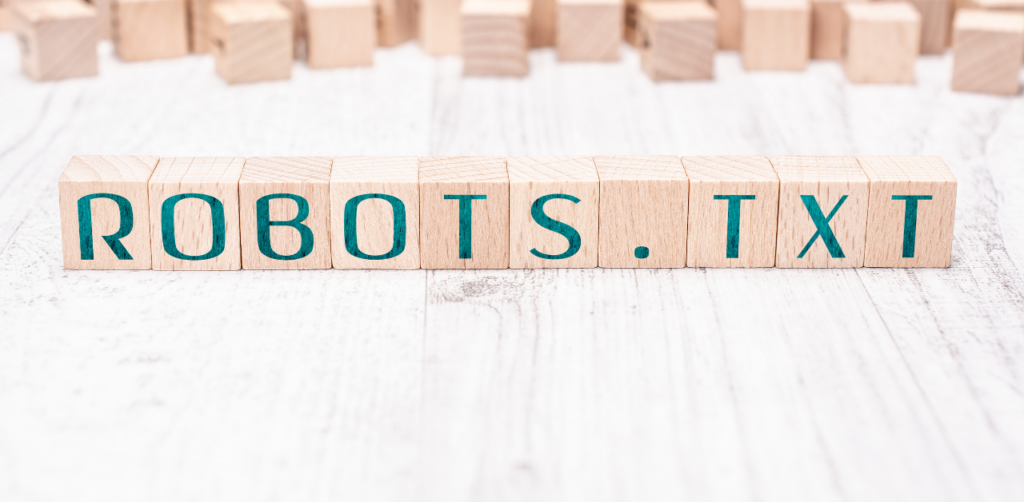 Wooden blocks spelling ROBOTS.TXT, highlighting its importance in controlling search engine crawling for technical SEO