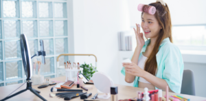 Beauty influencer livestreaming a makeup tutorial with cosmetic products