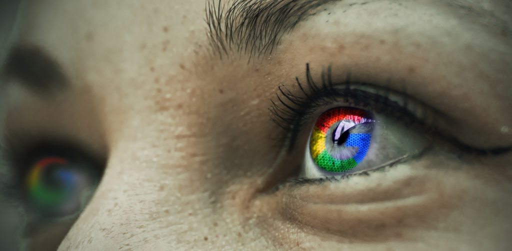 Close-up of an eye with a colorful Google logo reflection, symbolizing digital focus and search