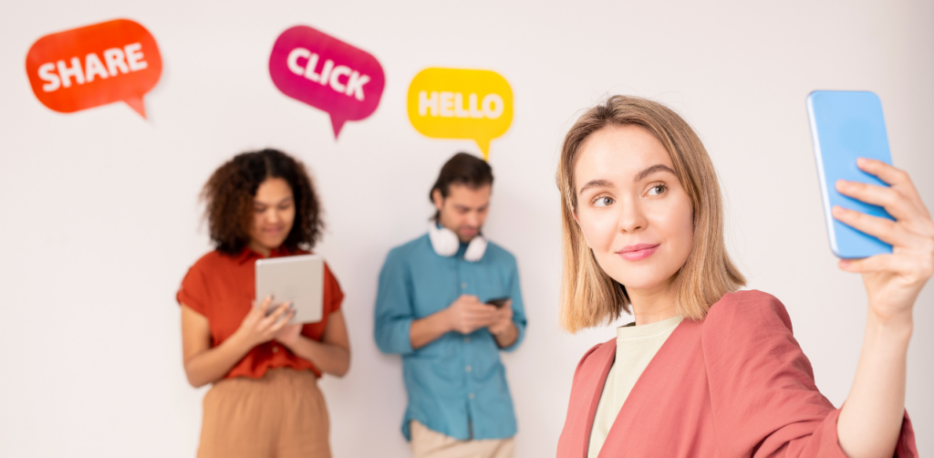 Young adults using mobile devices under speech bubbles saying “Share,” “Click,” and “Hello”