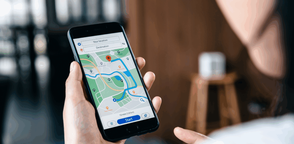 Woman holding smartphone showing GPS navigation route on a digital map app