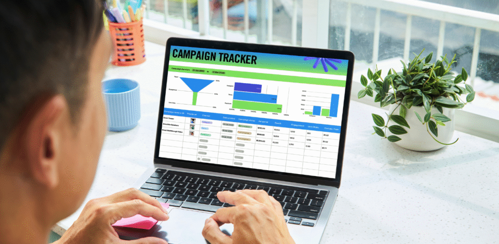 Person analyzing marketing data on a laptop showing a digital campaign tracker dashboard