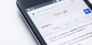 Smartphone screen showing a Google search for analytics, highlighting online data analytics tools and search engine results