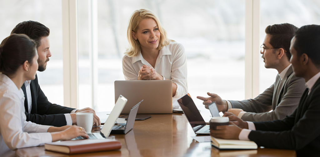 Professional business team gathered around a conference table during a collaborative office meeting